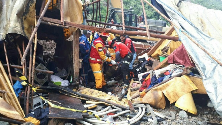 Fatal incident: Search and rescue personnel attempt to remove bodies of two traditional gold miners entrapped in a landslide in Banti village, Tembagapura, Timika, Papua, on July 29. 
