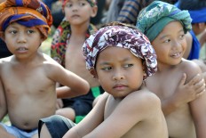  Several boys from the Sayuk Rukun Tibayan community in Klaten, Central Java, sit while waiting for their turn to perform the Tandur (to grow) dance. JP/Magnus Hendratmo