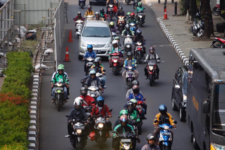 Motorcyclists travel along Jl. Rasuna Said in South Jakarta on Aug. 21, 2017.