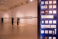 Visitors document artworks displayed at the International Artswitch exhibition in Jogja Gallery, Yogyakarta, on Aug. 15. JP/Tarko Sudiarno