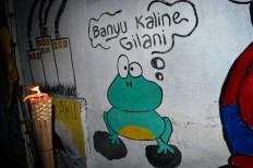 During the festival’s pre-event activities, the walls of Baron Cilik kampong were painted with environmental murals, including the illustration of a frog protesting the polluted condition of the river. JP/Stefanus Ajie