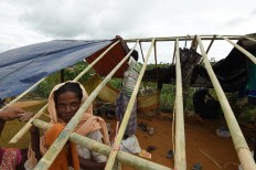 Rohingya refugees build a new makeshift shelters in the refugee camp of Thyangkhali near the Bangladeshi village of Gumdhum, on September 18, 2017. 
More than 400,000 Rohingya Muslims have now arrived in Bangladesh from their Buddhist dominated homeland to escape violence that the United Nations says could be ethnic cleansing. AFP/ Dominique Faget 