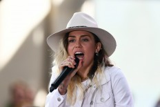 Toned down and tuned in, Miley Cyrus turns country balladeer