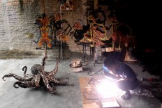  Agung welds a Gunungan (shadow puppet conical) from used parts. JP/Maksum Nur Fauzan