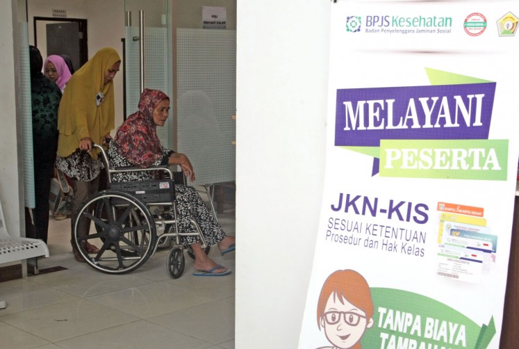 Hold tight: A patient and a member of Social Health Insurance Provider (BPJS) is pushed by her family member after undergoing a medical check-up at Bahteramas hospital in Kendari, Southeast Sulawesi. 
