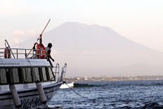 Authorities lower Bali volcano alert status