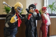 Indonesian cosplayers pose as characters from role-playing video game "Persona 5".