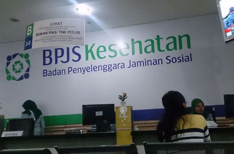 A customer seeks service from an office of the Health Care and Social Security Agency (BPJS Kesehatan) in Jakarta.