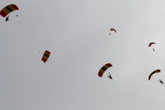 Six parachuters are seen flying and preparing for landing during their performance at the 2017 Bandung Air Show in Husein Sastranegara Air Force Base in Bandung, West Java, on Saturday, Nov. 11, 2017. JP/Arya Dipa