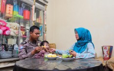 Before duty: Wahyudin spends time with his family during breakfast. JP/Bangkit Jaya Putra