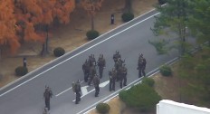 This screengrab made from video footage released by the United Nations Command on November 22, 2017 shows North Korea soldiers gathering on the north side of the Joint Security Area of the Demilitarized Zone (DMZ) after the defection of a North Korean soldier. 