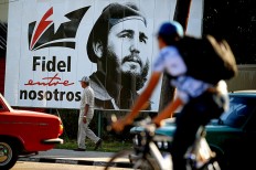 El Comandante: A man walks past a poster of late Cuban leader Fidel Castro, in Havana.