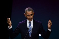 Obama takes on Trump and men in general at Paris event
