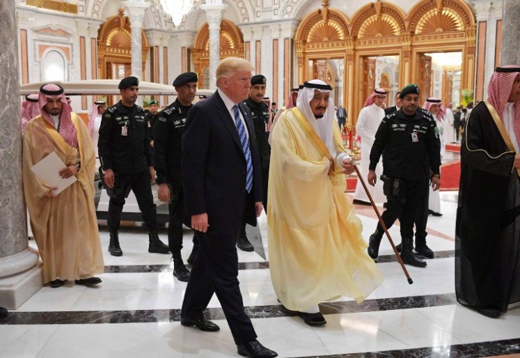 Close aides: US President Donald Trump (center, left) and Saudi Arabia's King Salman bin Abdulaziz al-Saud (center, right) arrive for the Arab Islamic American Summit at the King Abdulaziz Conference Center in Riyadh on May 21, 2017. 
