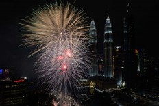 Fireworks illuminate the sky near Malaysia's Petronas Twin Towers during New Year celebrations in Kuala Lumpur on January 1, 2018. AFP/Mohd Rasfan