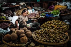 Old lady is sleeping around her products at Giwangan Market, Yogyakarta, Indonesia. The non-core part of inflation changes when food and energy prices move.
