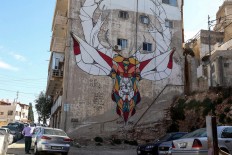 A picture taken on December 17, 2017 shows a graffiti mural on a wall in the Jordanian capital Amman. A tiny group of graffiti artists are on a mission -- daubing flowers, faces and patterns across the capital Amman to bring more colour to the lives of its four million inhabitants.
In a conservative society like Jordan's, the graffiti artists have constantly had to challenge convention to carve out a niche for their works, though still with limits as they steer away from politics and religion. AFP/Khalil Mazraawi  