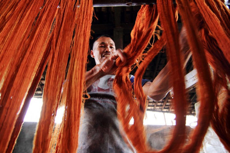 Yarns are dried prior to being woven in a textile factory in this undated file photograph.
