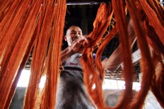 Yarns are dried prior to being woven in a textile factory in this undated file photograph.