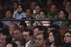 President Joko "Jokowi" Widodo (second left, rear) and Vice President Jusuf Kalla (left) attend the 71st birthday celebration for Indonesian Democratic Party of Struggle (PDI-P) founder Megawati Soekarnoputri (second right) in Jakarta. Megawati's daughter and Coordinating Human Development and Culture Minister Puan Maharani was also present at the event.
