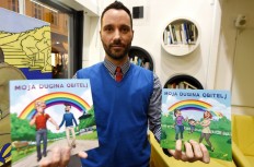 Ivo Segota, author of the book 'My Rainbow Family', the country's first picture book for children about 'rainbow families', holds copies of the book in his hands after its presentation in Zagreb on January 18, 2018. 