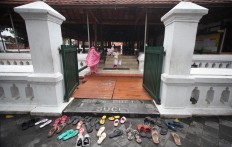 Sandals are scattered in front of the mosque prior to the Dzuhur (midday) prayer. JP/Boy T. Harjanto