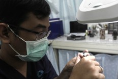 Close inspection: Rizwan puts the final touches on an artificial eye. JP/ Ben Latuihamallo