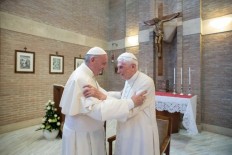 This handout picture released on February 15, 2018 by the Vatican press office shows Pope Francis (L) greeting Pope Benedict XVI at the Vatican, on June 28, 2017. 
