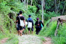 Baduy people go about their activities in Kanekes village, which has been declared a cultural conservation area, in Lebak regency, Banten, on Oct. 15, 2017.