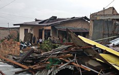 Damaged: Residents clean up debris after a whirlwind hit their houses on Feb. 26 in Siboras village, Sumbul district, Dairi regency, North Sumatra.