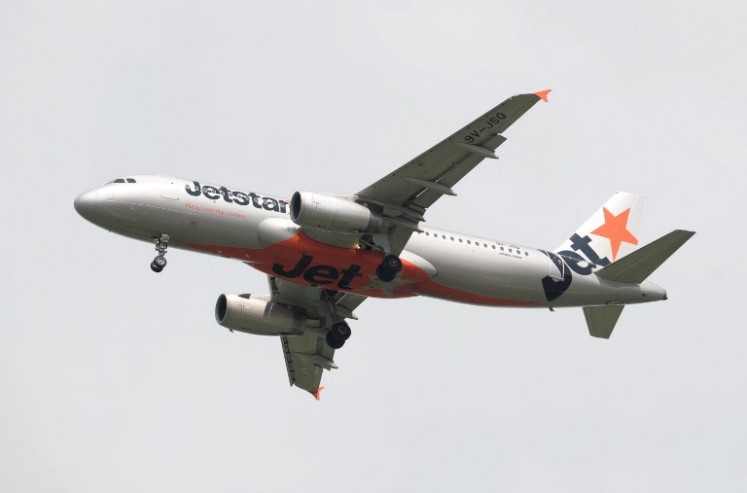 This photograph taken on May 4, 2014 shows an aircraft of Australian low-cost carrier Jetstar Airways approaching Changi International Airport in Singapore. 
