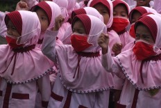 Female students attend physical education class while still wearing their surgical masks. JP/Maksum Nur Fauzan