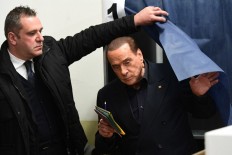 Silvio Berlusconi, leader of right-wing party Forza Italia, prepares to vote on March 4, 2018 at a polling station in Milan. 