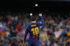 Barcelona's Argentinian forward Lionel Messi celebrates after scoring during the Spanish league football match FC Barcelona against Club Atletico de Madrid at the Camp Nou stadium in Barcelona on March 04, 2018. 