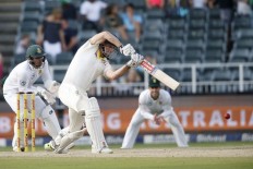 Australia's batsman Shaun Marsh (center) plays a shot during the second day of the fourth Test cricket match between South Africa and Australia at Wanderers Cricket Ground on March 31, 2018 in Johannesburg. 