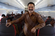 The founder of Lion Air, Rusdi Kirana, poses for a photograph in the aisle of a new Airbus A320 during its maiden flight from Jakarta to Batam for Batik Air on Nov. 21, 2014.