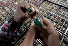 A potential buyer chooses two gemstones. JP/Boy T. Harjanto