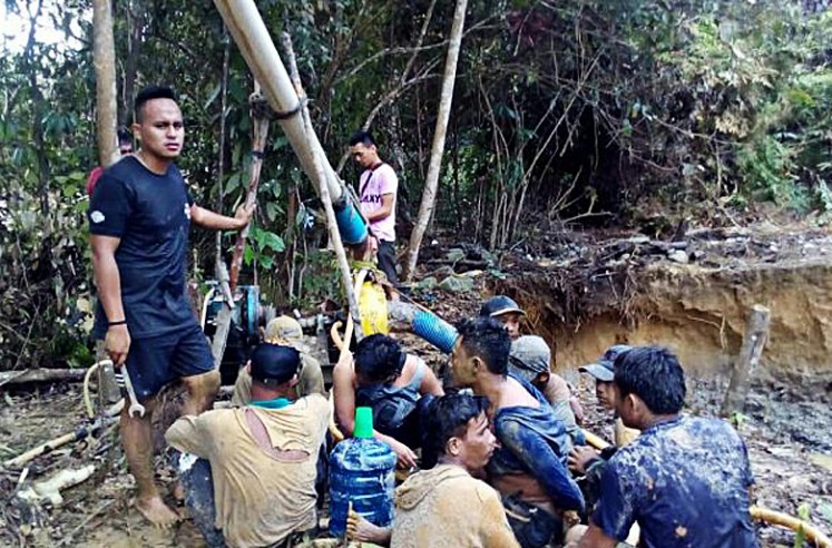 The police arrest nine illegal gold miners on Dec. 9, 2016, in Kuantan Singingi, Riau. The Kuantan Singingi regency administration plans to convert former illegal gold mines into rice fields to boost rice production.