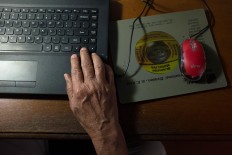 Digital savvy:Mangku uses his laptop to work from home in Kebayoran Lama. JP/Jerry Adiguna