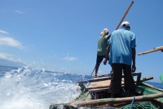 Men in Lamalera village, Lembata regency, hunt for the whale using harpoon.