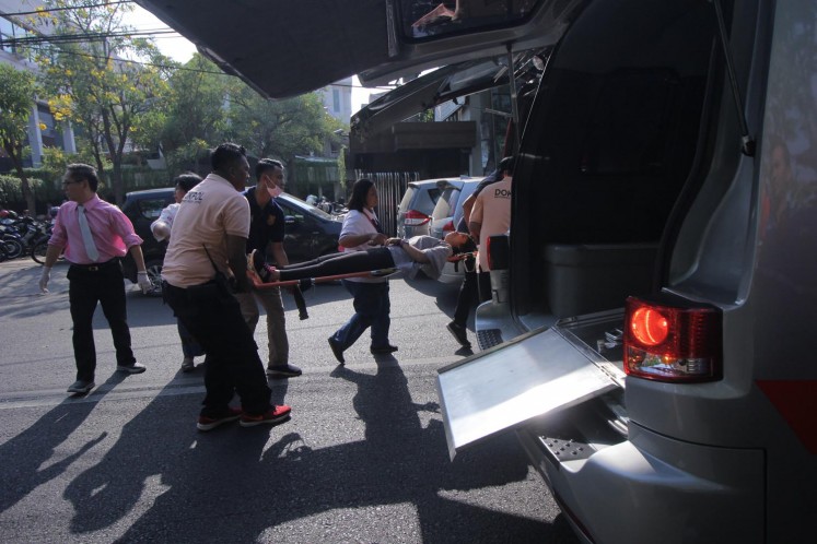 Officials evacuate a victim of the bombing attack at Gereja Kristen Indonesia Church on Jl. Diponegoro, Surabaya, East Java, on Sunday.
