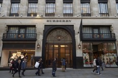 Pedestrians pass the Burberry store as they walk along Regent Street in central London on November 9, 2017. Burberry Group Plc will acquire an Italian leather-goods factory as the company works to ramp up its business in luxury handbags under Chief Executive Officer Marco Gobbetti.