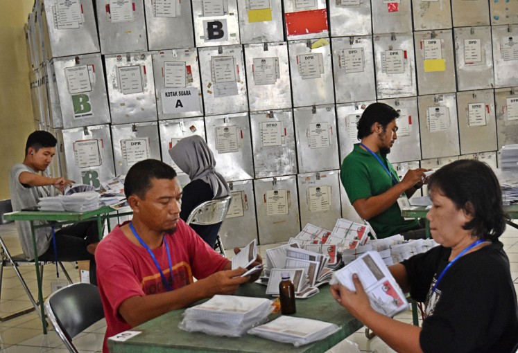 Election workers fold ballots on May 20, 2018 in Ungaran, Semarang regency, Central Java, ahead of the province’s gubernatorial election that year.