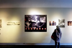 Victory is ours: A visitor looks at photos that depict people jumping for joy after the resignation of dictator Soeharto.