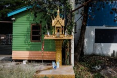 A spirit house is located on a sidewalk in Lopburi, Thailand. JP/Anggara Mahendra