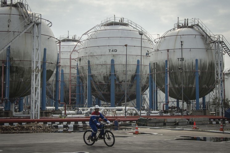 Workers carry out activities near storage tanks at an LPG depot in Tanjung Priok, Jakarta, on May 25, 2018.