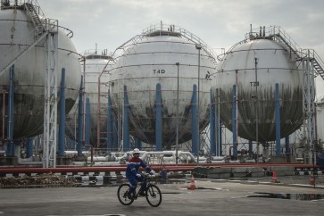 Workers carry out activities near storage tanks at an LPG depot in Tanjung Priok, Jakarta, on May 25, 2018.