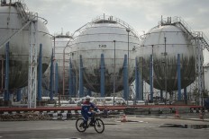 Workers carry out activities near storage tanks at an LPG depot in Tanjung Priok, Jakarta, on May 25, 2018.