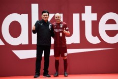 Spanish midfielder Andres Iniesta (R) and Hiroshi Mikitani (L), owner of Rakuten and Vissel Kobe club, pose for pictures on the pitch of Noevir Stadium in Kobe on May 26, 2018. Iniesta just signed a contract with Japanese soccer team Vissel Kobe. 