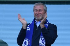Chelsea's Russian owner Roman Abramovich applauds, as players celebrate their league title win at the end of the Premier League football match between Chelsea and Sunderland at Stamford Bridge in London on May 21, 2017. 
